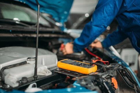 mechanic checking car engine