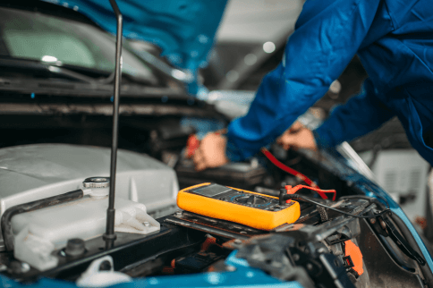 mechanic checking car engine